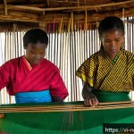 Home 23 르완다 전통 직물 산업의 경제적 기여 - A vibrant traditional Rwandan weaving village scene featuring skilled artisans, predominantly women ...